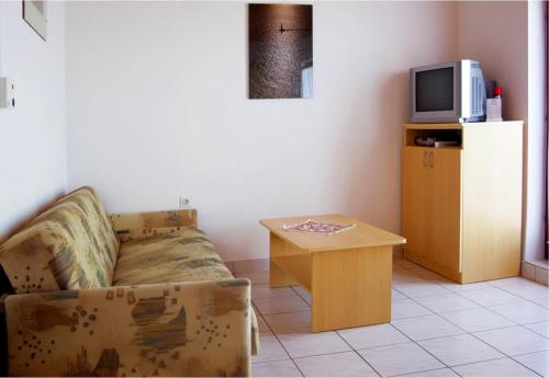 a living room with a couch and a small table at Apartments Marija - 30m from the beach in Murter