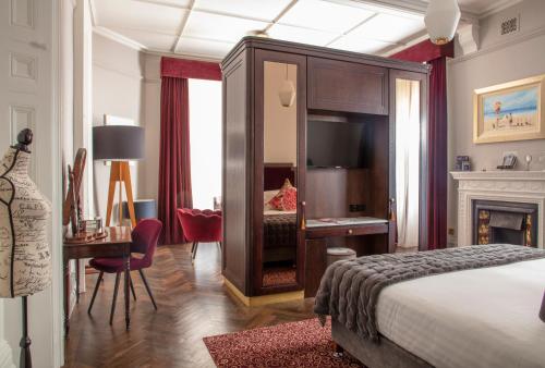 a hotel room with a bed and a desk and a bedroom at The Wilder in Dublin