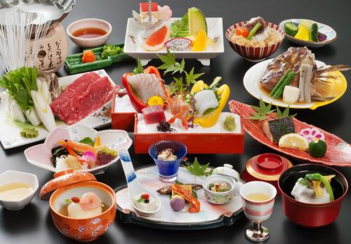 a group of plates of food on a table at Dogo Prince Hotel in Matsuyama