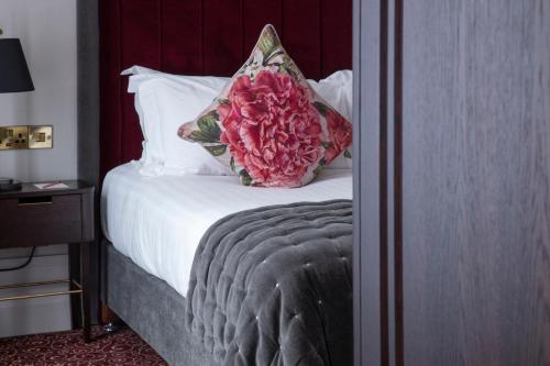 a bedroom with a bed with a pillow on it at The Wilder in Dublin