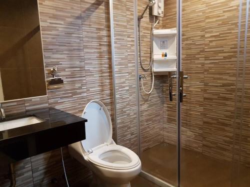 een badkamer met een toilet, een douche en een wastafel bij DB Plus 2 in Ban O Pao