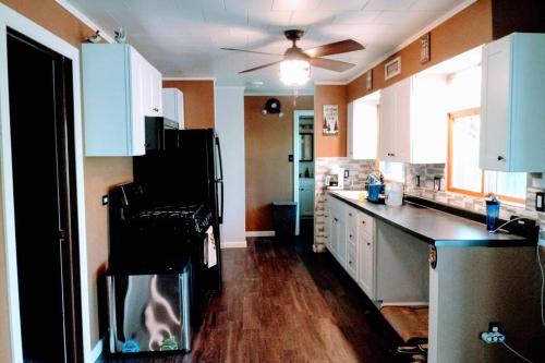 a kitchen with a dog sitting on a chair in the kitchen at Wisconsin Dells Cabin in the Woods - VLD0423 in Wisconsin Dells