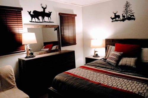 a bedroom with a bed with deer decals on the wall at Wisconsin Dells Cabin in the Woods - VLD0423 in Wisconsin Dells
