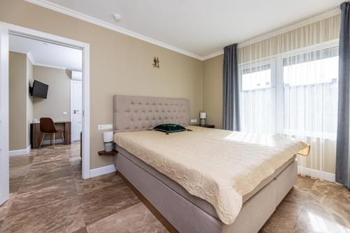 a bedroom with a large bed in a room at Sakura_INN Palanga in Palanga