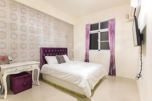 a bedroom with a bed and a window at Square B&B in Taitung City