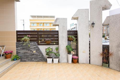 a balcony with potted plants on a building at Square B&B in Taitung City