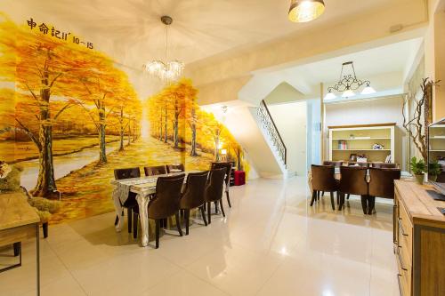 a dining room with a painting on the wall at Square B&B in Taitung City