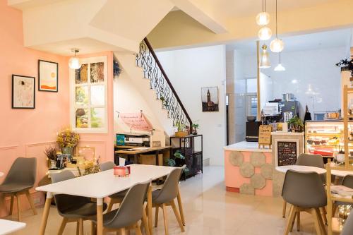 a restaurant with tables and chairs and a counter at Square B&B in Taitung City