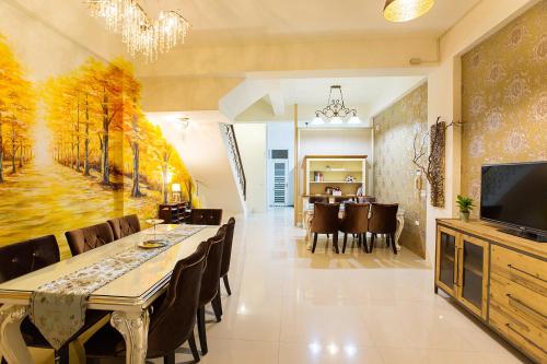 a dining room with a large painting on the wall at Square B&B in Taitung City