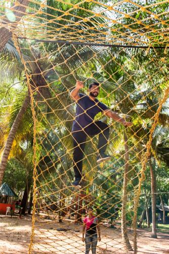 a man standing on top of a net at GoGo Land Resort & Adventurous Sports in Pūvār