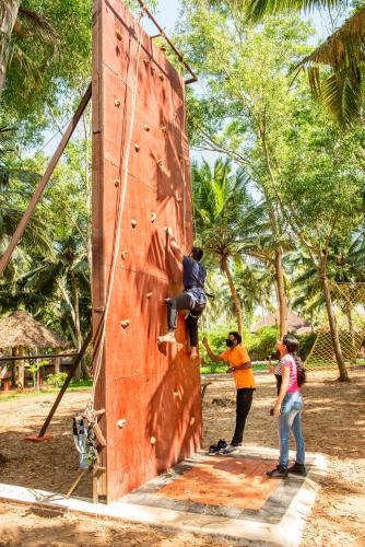 a group of people climbing on a rock wall at GoGo Land Resort & Adventurous Sports in Pūvār