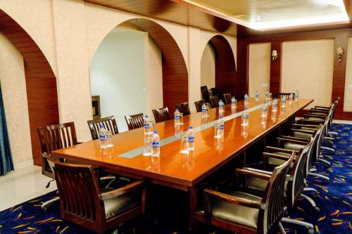 a large long table in a room with chairs at juSTa Palampur Resort & Convention Centre in Pālampur