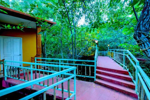 a set of stairs leading to a house with trees at GoGo Land Resort & Adventurous Sports in Pūvār