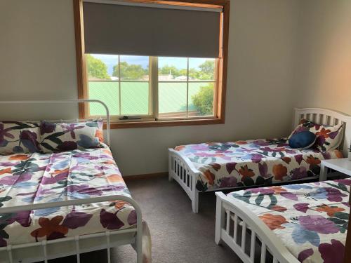 a room with two beds and a window at Serenity on Sturt in Ballarat