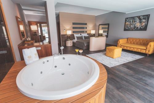 a large bathroom with a large tub in a room at Orka Cove Hotel Penthouse & Suites Adults Only in Fethiye