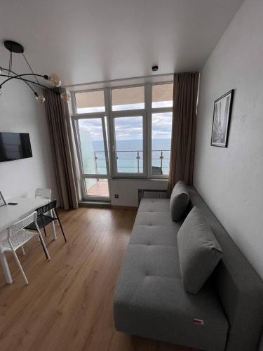 a living room with a couch and a table at Arcadia apartment & sea terrace in Odesa
