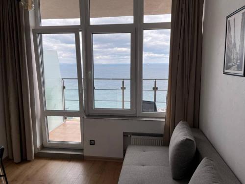 a living room with a large window with a view of the ocean at Arcadia apartment & sea terrace in Odesa