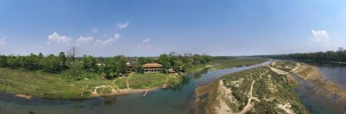 a house on an island in the middle of a river at Jungle Villa Resort - Near Chitwan National Park in Chitwan