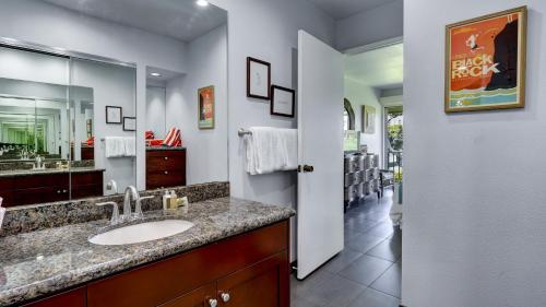 a bathroom with a sink and a large mirror at Maui Eldorado - J207 in Lahaina