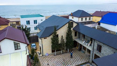 an aerial view of a house with a man standing in front of it at Guest house U Morya in Derbent