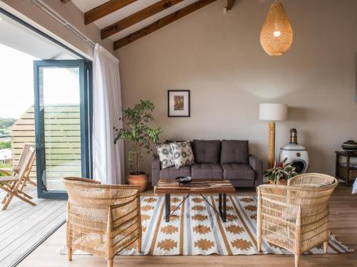 a living room with a couch and a table at Ridge House in Hermanus