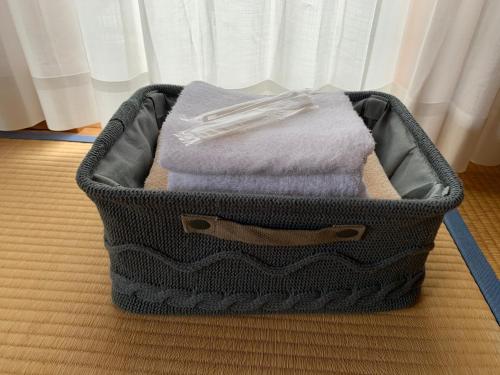 a suitcase filled with towels sitting on a bed at Guest house En in Fujiyoshida
