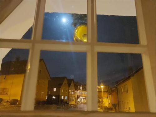 a window with a view of a city at night at Gasthof Russenbräu in Tiefenbach