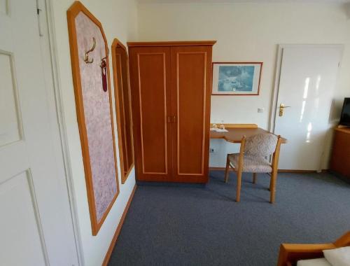 a room with a door and a table with a chair at Gasthof Russenbräu in Tiefenbach