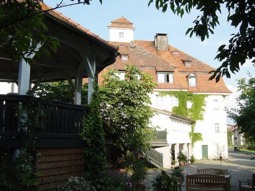 a large white building with a clock tower at Gasthof Russenbräu in Tiefenbach