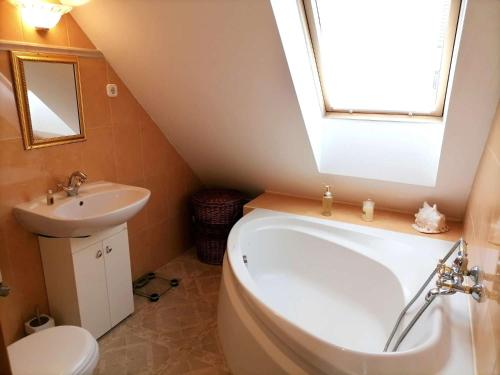 a bathroom with a white tub and a sink at Budapest beauty in Budapest