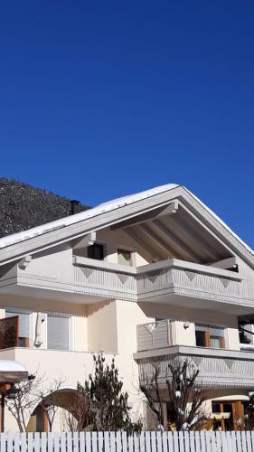 a white building with a white fence in front of it at Haus Martina in Sand in Taufers