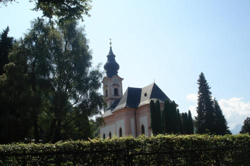 a church with a clock tower on top of it at Hotel Hofmann in Salzburg