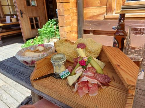 a tray of food on a wooden table with food at Haus Martina in Sand in Taufers