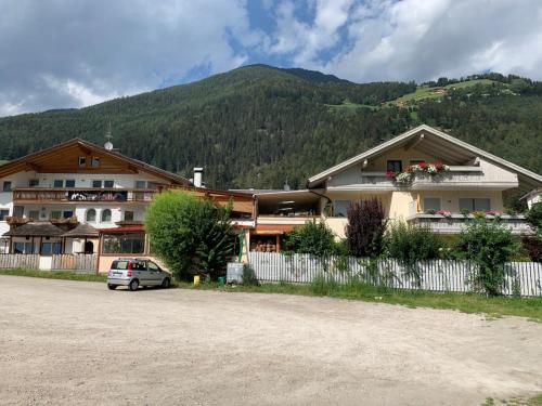 a building with a car parked in front of it at Haus Martina in Sand in Taufers