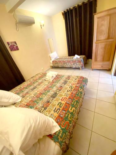Postel nebo postele na pokoji v ubytování Charmant appartement avec piscine partagée à Pointe-Noire - 36m²
