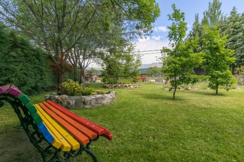 a colorful park bench sitting in a field of grass at El Jardín de Alameda in Alameda del Valle