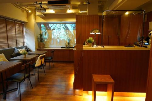 a restaurant with tables and chairs and a counter at Sutton Place Hotel Ueno in Tokyo