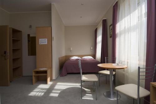 Postel nebo postele na pokoji v ubytování TOSS Hotel