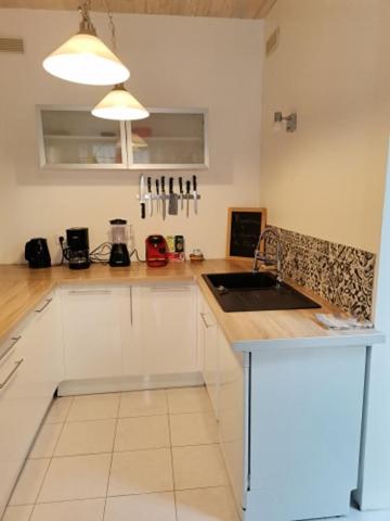 a kitchen with a sink and a counter top at La Maison du Palus in Plouha