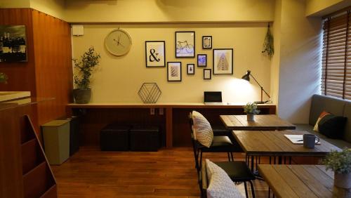 a dining room with a table and a clock on the wall at Sutton Place Hotel Ueno in Tokyo