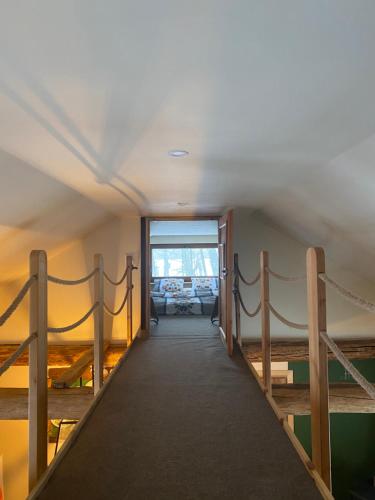 a hallway leading to a room with a ramp with a ramp at Siedlisko Odpoczynkowo in Nowosiółki