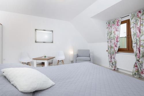 a bedroom with a bed and a chair and a window at Krab in Rewal
