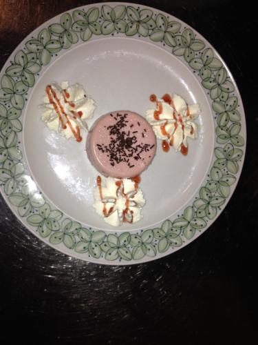 a plate with a dessert on a table at Hotel Restaurant Cristal in Braunwald