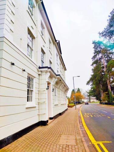 a white building on the side of a street at The Northwick Arms Hotel in Evesham