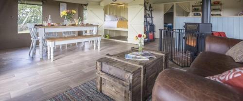 a living room with a couch and a table at Midleydown Luxury Glamping in Exeter