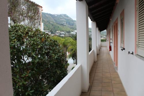 a corridor of a building with a view of a mountain at Hotel Castiglione in Ischia