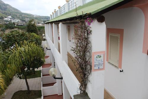 a white building with flowers on the side of it at Hotel Castiglione in Ischia