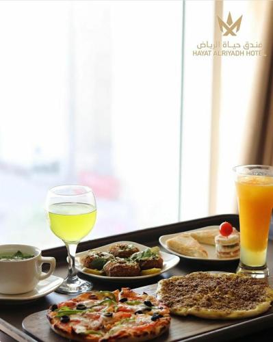 a tray of breakfast foods and drinks on a table at Hayat Al Riyadh Hotel in Riyadh
