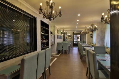 a dining room with a long table and chairs at La Maison by Dia Hotels and Homes in Panaji