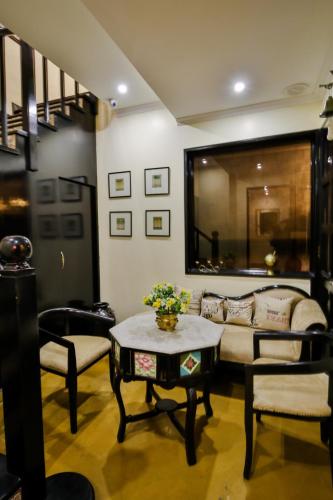 a living room with a couch and a table at La Maison by Dia Hotels and Homes in Panaji